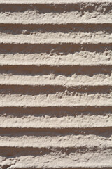 Wall texture with a series of parallel, horizontal grooves or channels