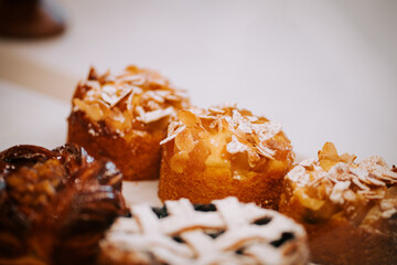 Delightful pastry selection featuring assorted cakes with nuts and fruit in a charming pastry shop display
