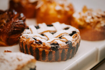 Delightful assortment of pastries and cakes displayed in a cozy pastry shop during the afternoon hours