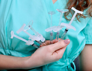 doctor holds syringes