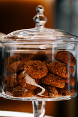 Delightful cookie jar displayed in a cozy coffee shop window, inviting customers to indulge in sweet treats