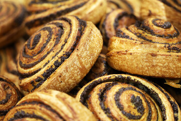 Puff pastry with poppy closeup. Freshly baked rolls for breakfast