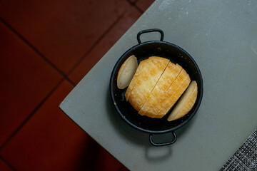 Traditional Alentejo cheese, sliced and served on a small plate table in a cozy restaurant,...