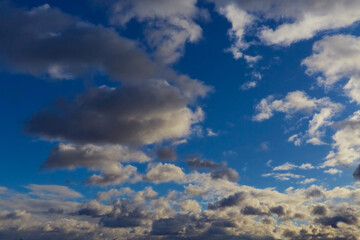 Whimsical shapes of clouds create a fairytale-like landscape effect.