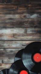 Vinyl records with red labels are arranged on a rustic wooden surface, evoking a sense of nostalgia...