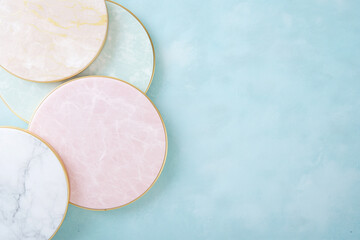 Three small round plates with gold and pink designs on them