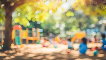 Gardinen Blurry image of a park with children playing and a tree in the background. Scene is playful and carefree, as the children are enjoying themselves in the park © Людмила Мазур