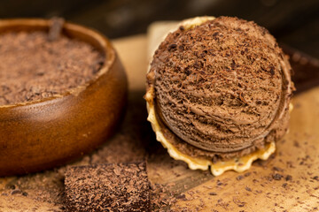 chocolate ice cream in a cone on a board