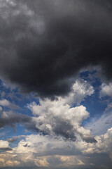 Storm cloudy dramatic sky with dark rain grey and white cumulus cloud and blue sky background texture, thunderstorm, heaven