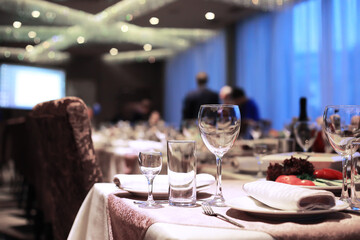 cutlery on the table in a restaurant table setting, knife, fork, spoon, interior