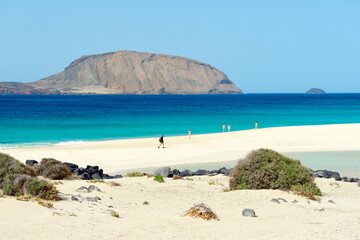 Lanzarote, Canary Islands. Over white sands of Playa de las Conchas on Isla Graciosa, Lanzarote. Toward island of Montana Clara