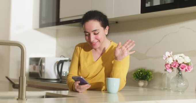 Happy beautiful girl talking on phone in the home. Woman use phone.