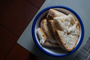 A bowl of sliced Alentejo bread, ready to be added to the traditional Portuguese tomato soup,...