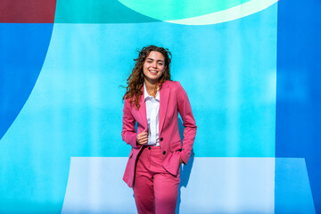 Beautiful young corporate businesswoman strolling in the city
