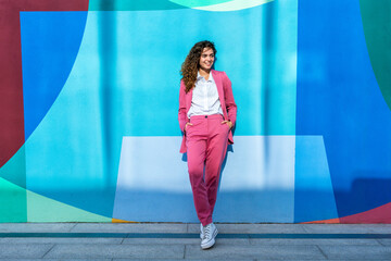 Beautiful young corporate businesswoman strolling in the city