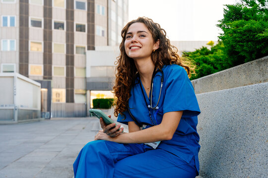 Beautiful young nurse or doctor strolling in the city