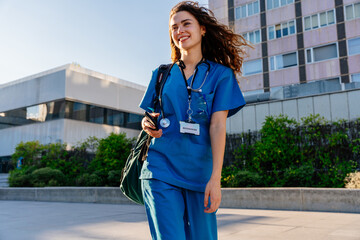 Beautiful young nurse or doctor strolling in the city