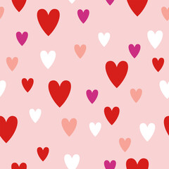 Seamless pattern with red, pink, and white hearts on a soft pastel pink background. Valentine’s Day and love theme design for greeting cards, textiles, gift wraps and wedding prints