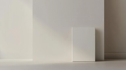 Minimalist design with white book against a wall casting soft shadows