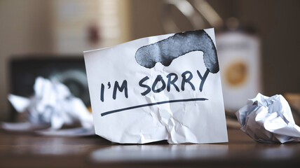 An apology note, handwritten, with smudged ink and torn paper Understanding of Forgiveness and Regret
