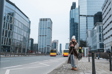 woman travels winter city, solo travel, sightseeing. She admires architecture and city landscapes, freedom, discoveries, the spirit of independent travel.