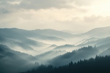 Obraz premium Misty mountain landscape at sunrise, layers of hills shrouded in fog, creating a serene and mystical atmosphere.