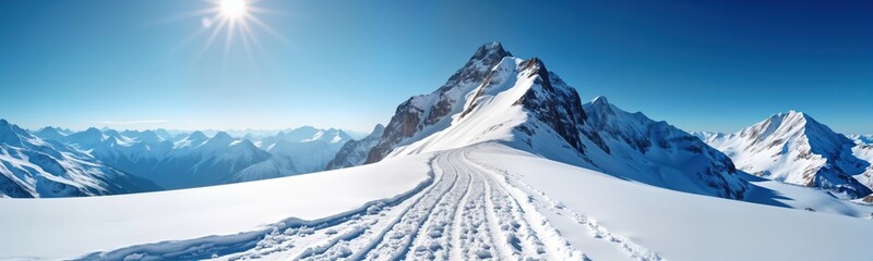 Obraz premium Snowy mountain peak panorama in Alps. Clear blue sky. Snow covered slopes. Ski tracks on snow. Scenic winter landscape. Sunny day. Adventure travel. Europe. Nature. Winter sports. Tourism. Majestic.