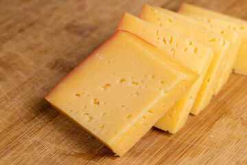 hard cheese with holes on the cutting board