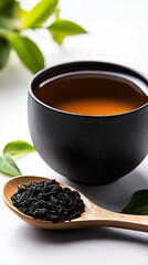 A black ceramic cup filled with Chinese tea, placed on a white surface