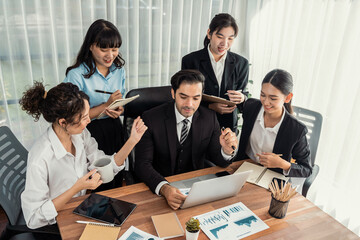 Fototapeta premium Diverse of business people from various ethnic group working in modern office environment. Productive and multi ethnic office workers engage in discussion for strategic business marketing. Meticulous