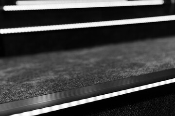 Modern staircase design, black and white minimalist interior details, LED lit steps, contemporary...