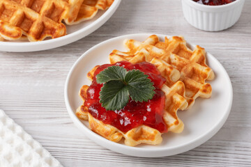 Waffles with strawberry jam for breakfast