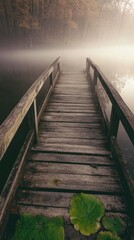 Fototapeta premium A serene wooden bridge shrouded in mist, leading to a tranquil water's edge, embodies peace and contemplation in a beautifully natural setting.