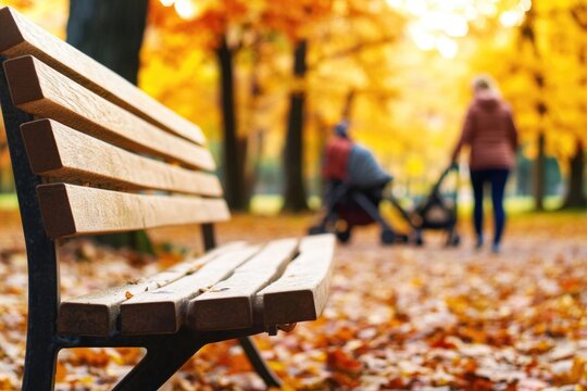 A wooden park bench sits in the middle of a green park