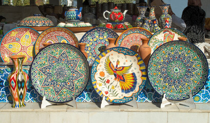 Colorful traditional painted plates and cups in bazaar in Uzbekistan, Asia