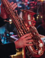 Concert view of saxophonist musician, saxophone sax player with vocalist and musical band during...