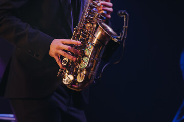 Concert view of saxophonist musician, saxophone sax player with vocalist and musical band during...