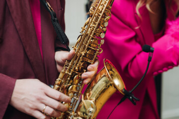 Concert view of saxophonist musician, saxophone sax player with vocalist and musical band during...