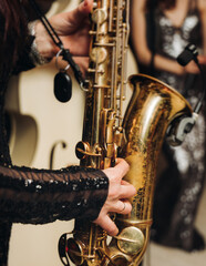 Concert view of female saxophonist musician, saxophone sax player woman with vocalist and musical...