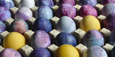 Easter eggs. Organized in a cardboard egg tray. Colorful, bright, handmade, decorated. Sustainable...
