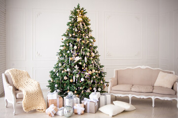 Elegant Christmas interior with a decorated tree in gold and white, wrapped gifts, a vintage beige sofa, and an armchair with a cozy knit blanket. Bright white walls create a festive, minimalism