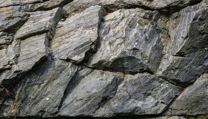 A grey rough stone slate rock texture with an abstract natural pattern, showcasing a rugged, earthy surface perfect for backgrounds and design.