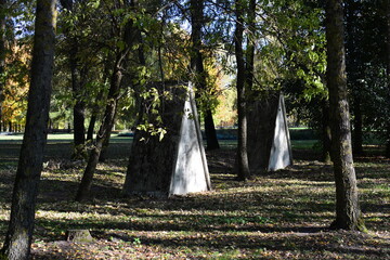 Old soviet public toilet in city park in autumn sunny day. Creepy small buildings in nature.
