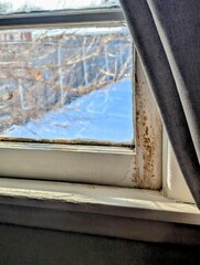 Vintage Wooden Window Frame with Black Mold and Winter Snow View in a 1950s Midwest Home