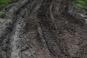 Tire track in the sand. Vehicle tracks in the mud. Mud.
