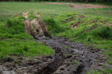 Tire track in the sand. Vehicle tracks in the mud. Mud.