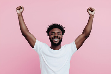A man with a big smile on his face is holding his hands up in the air