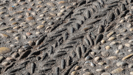 Texture of a handmade paving made of river pebbles