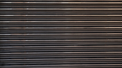 Texture of a metal shutter with lines and reflections