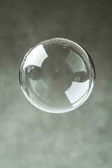 Transparent bubble gently floating, reflecting soft light and su